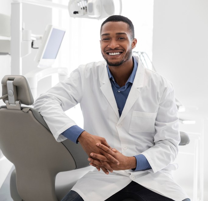 dentist sitting in chair smiling