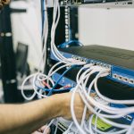 IT technician organizing network cables for a growing business