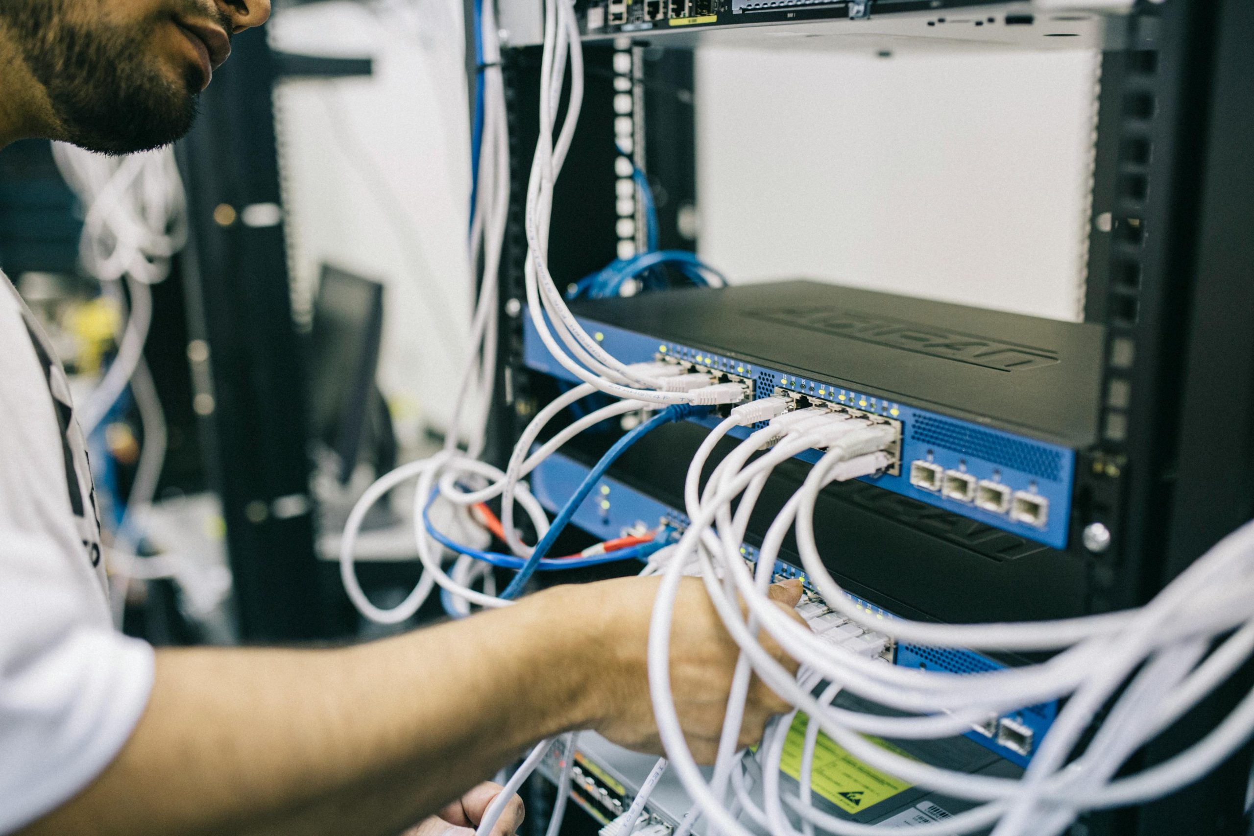IT technician organizing network cables for a growing business